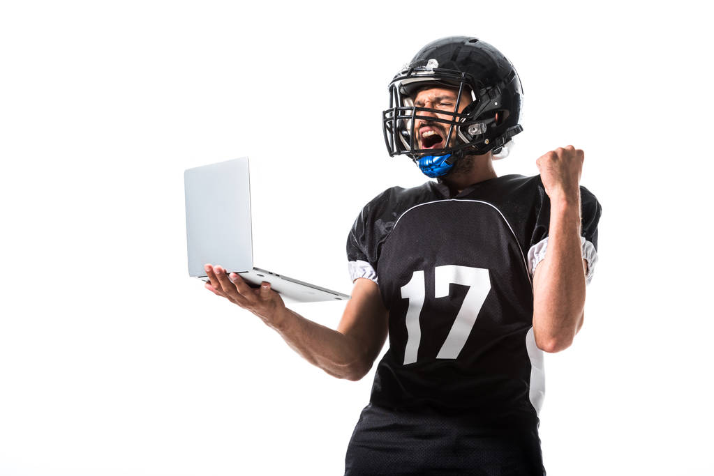American Football player with laptop cheering with clenched hand Isolated On White - Photo, Image