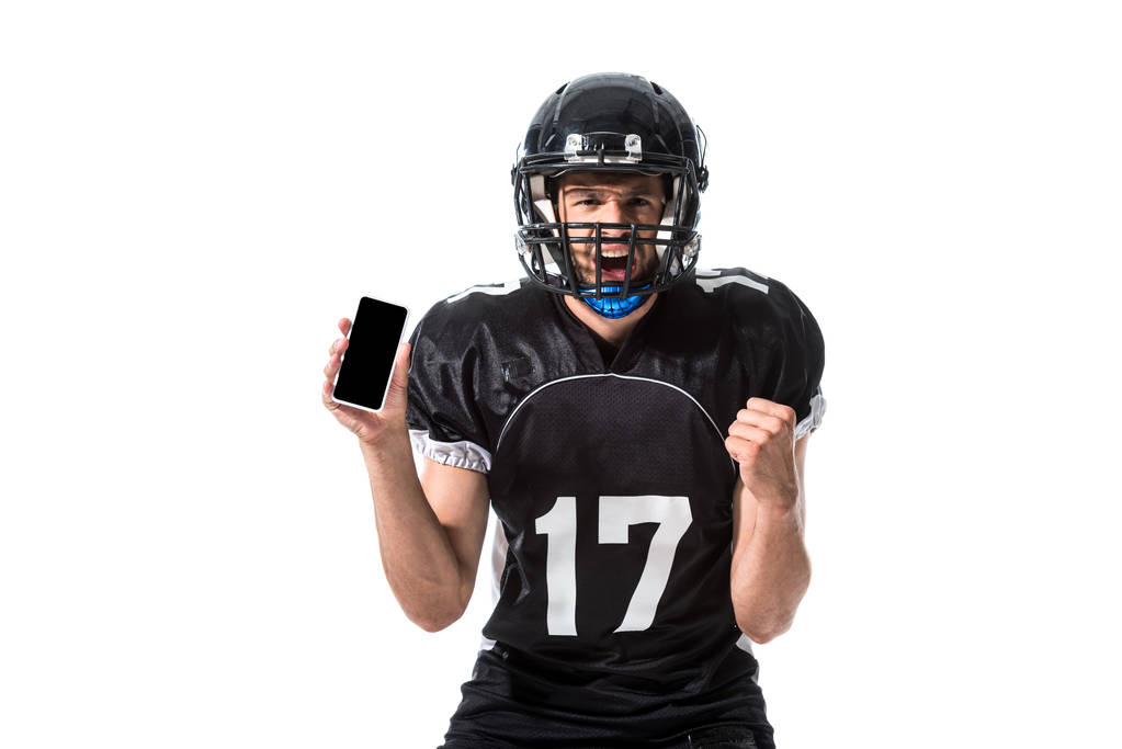 φωνάζοντας αμερικανικό ποδοσφαιρικό παίκτη με smartphone απομονωμένη σε λευκό - Φωτογραφία, εικόνα