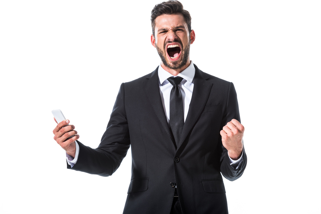 gritando hombre de negocios con teléfono inteligente y mano apretada aislado en blanco
 - Foto, Imagen