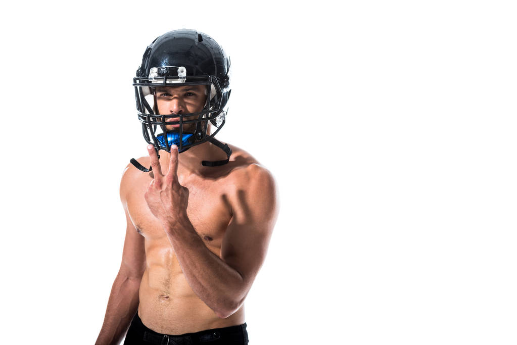 shirtless American Football speler in helm doen vredesteken geïsoleerd op wit - Foto, afbeelding