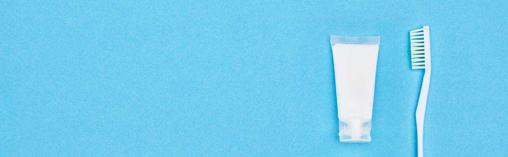 plano panorámico de cepillo de dientes y pasta de dientes aislado en azul
  - Foto, Imagen