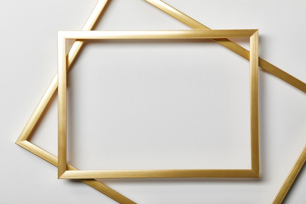 top view of empty golden frames on white background with copy space - Photo, Image
