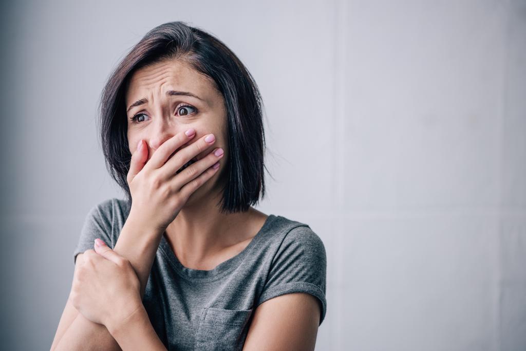 depressed brunette woman covering mouth and crying at home - Photo, Image