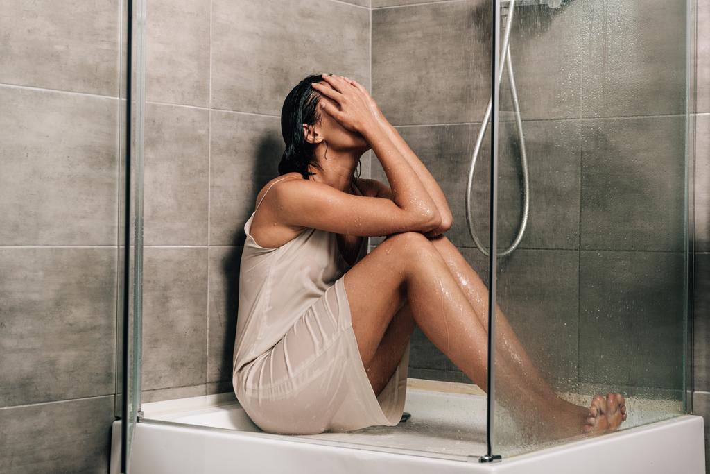 lonely worried woman covering face while sitting in shower at home - Photo, Image