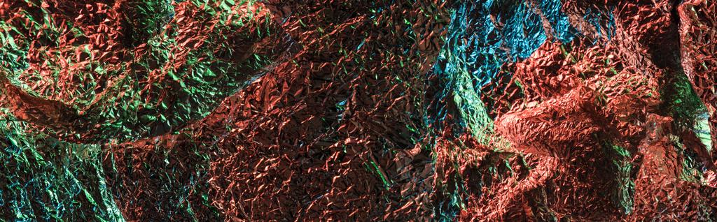 panoramic shot of abstract background of textured crumpled foil with colorful lighting - Photo, Image