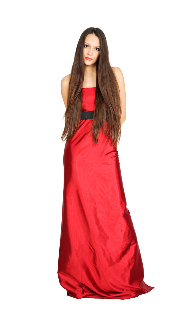 Cute girl wing long hair wearing long red dress stands isolated - Photo, Image