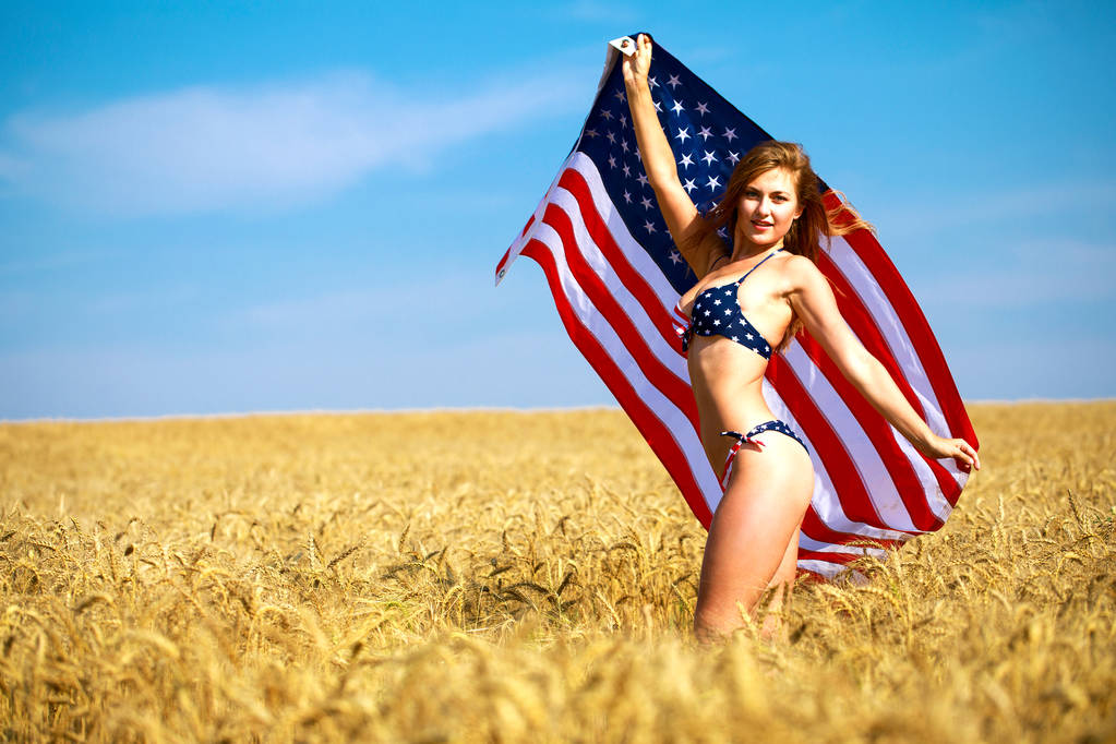 Sexy woman in sexy American flag bikini in a wheat field - Photo, Image