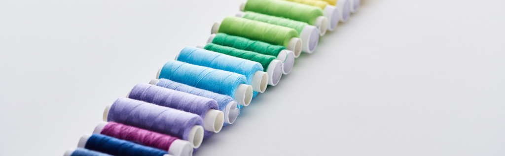 selective focus of bright and colorful threads on white background  - Photo, Image
