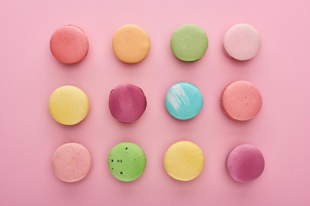 flat lay with colorful delicious French macaroons on pink background - Photo, Image