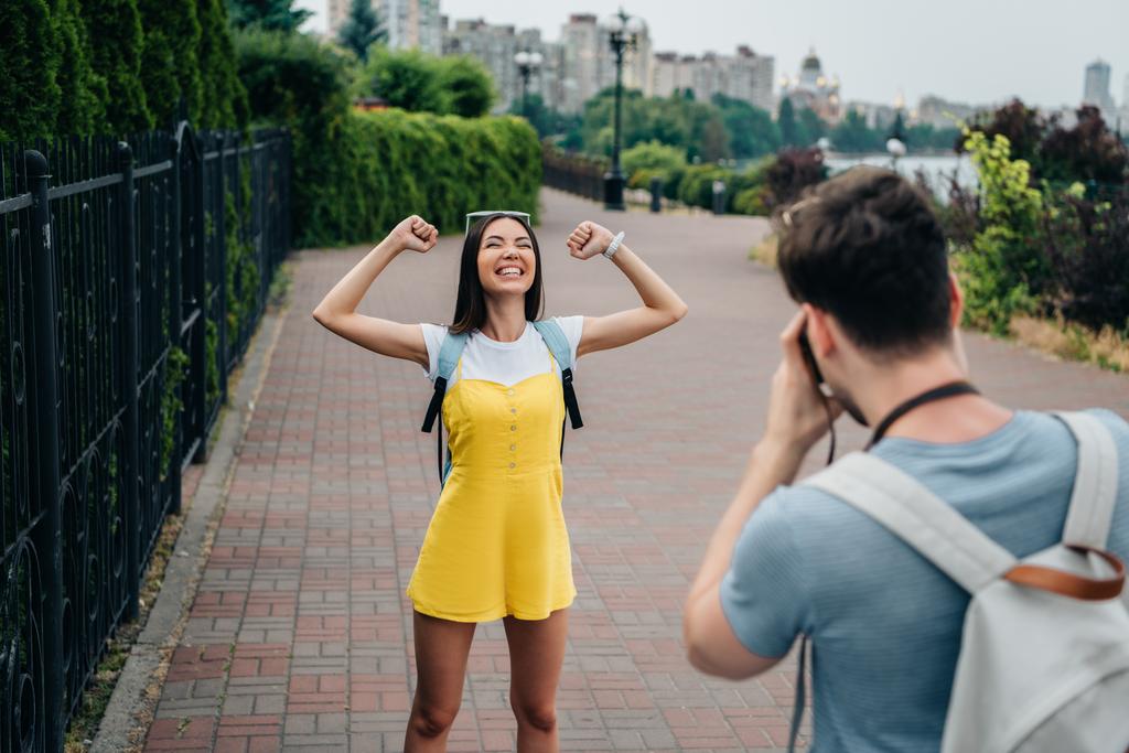 homem tomando foto e asiático mulher mostrando sim gesto
 - Foto, Imagem
