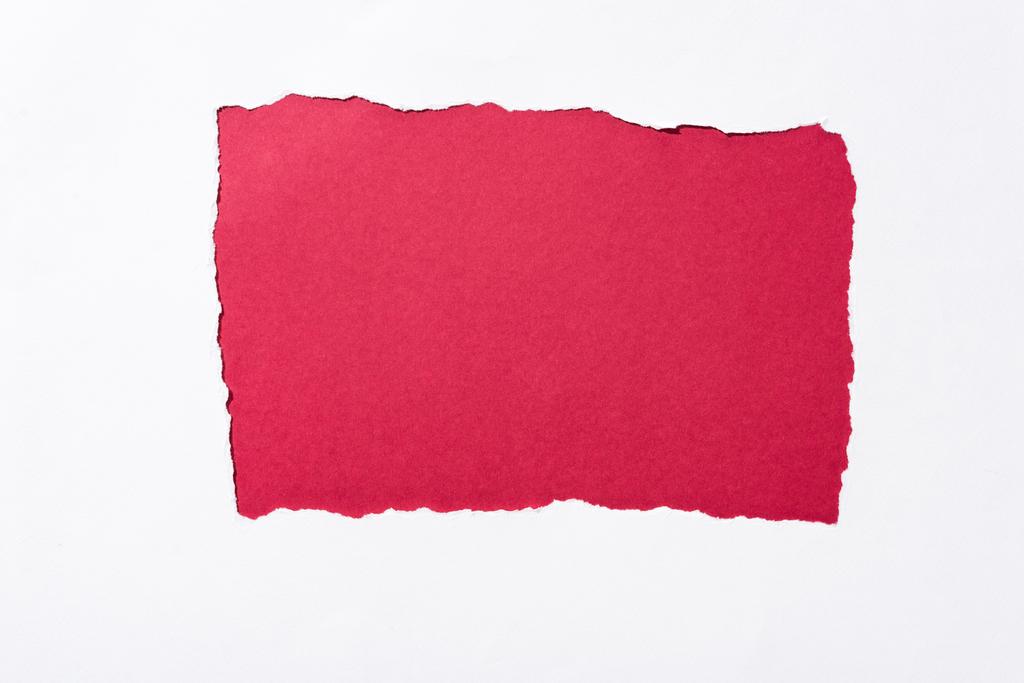 red colorful background in white torn paper hole - Photo, Image