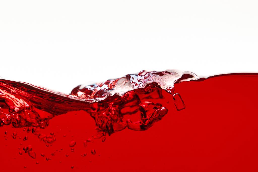 liquide lumineux rouge avec éclaboussure isolé sur blanc
 - Photo, image