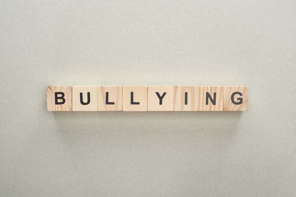 top view of wooden blocks with bullying lettering on grey background - Photo, Image