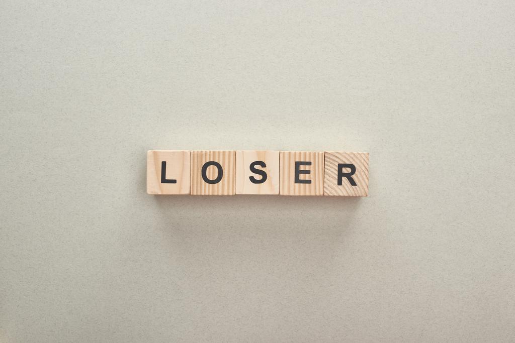 top view of wooden blocks with loser word on grey background, bullying concept - Photo, Image