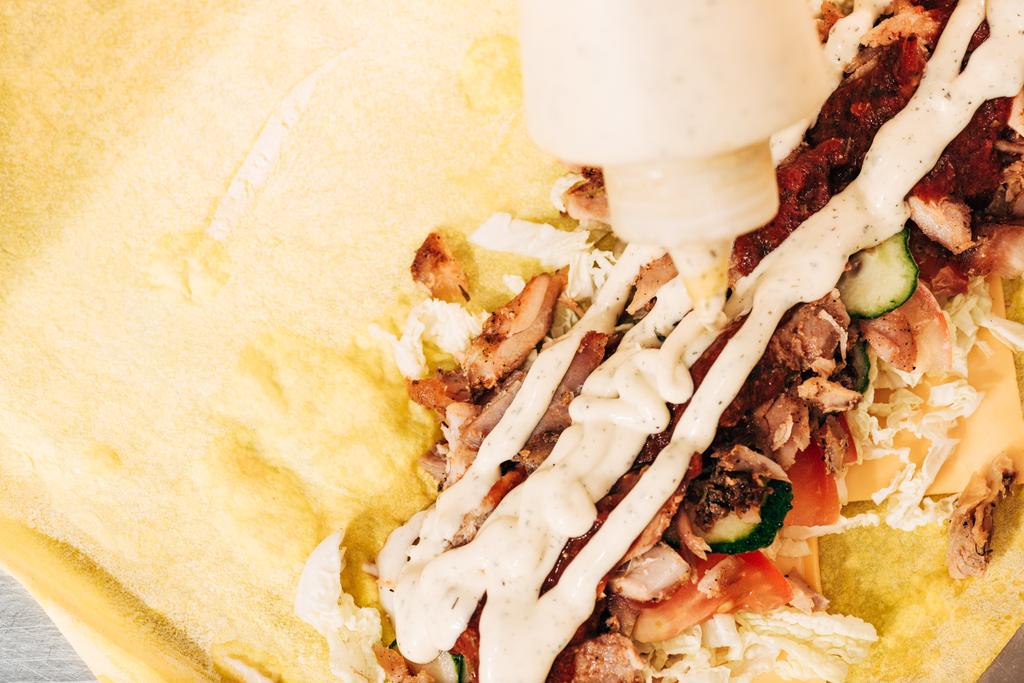 top view of doner kebab and bottle with sauce - Photo, Image