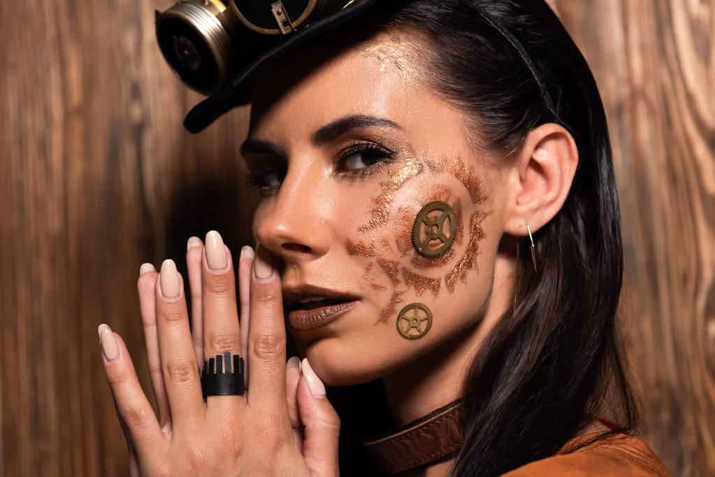 pensive steampunk woman showing please gesture on wooden - Photo, Image