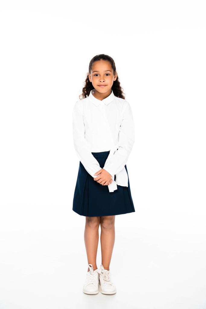 full length view of cute african american schoolgirl posing at camera on white background - Photo, Image