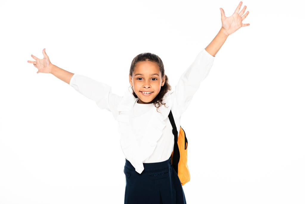 happy african american american schoolgirl gesturing with raised hands while looking at camera isolated on white - Photo, Image