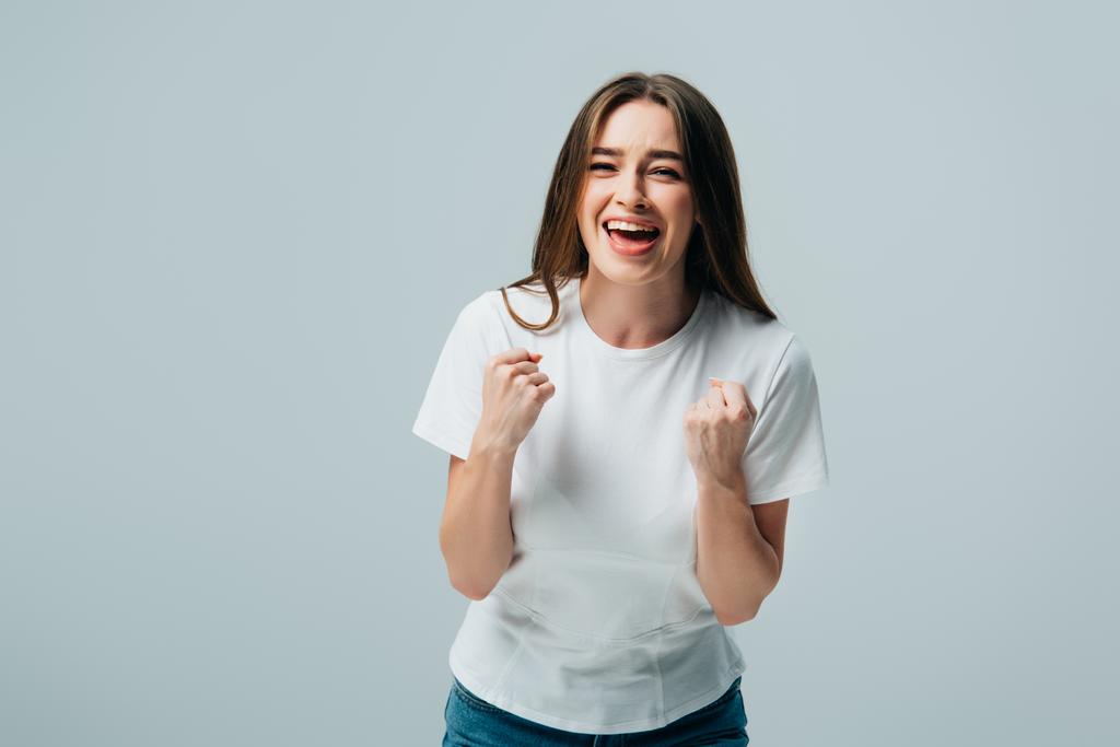 ευτυχισμένο όμορφο κορίτσι με λευκό μπλουζάκι που δείχνει Ναι χειρονομία απομονωθεί σε γκρι - Φωτογραφία, εικόνα