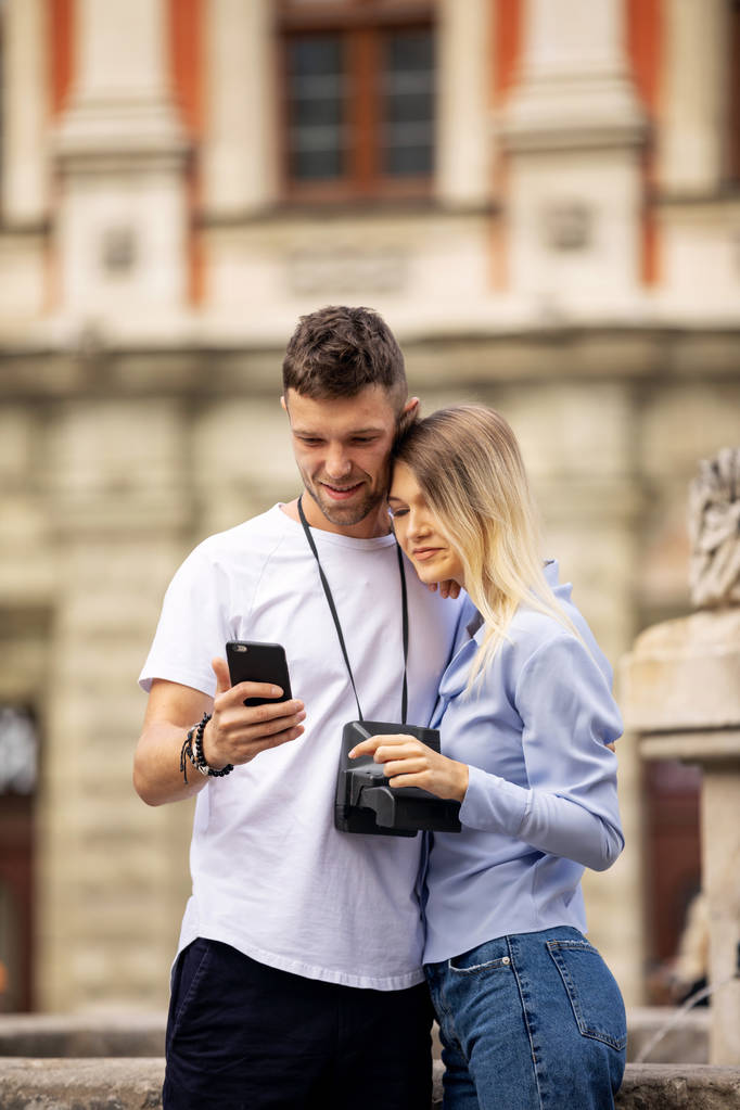 Viaje selfie pareja tomando fotos con el teléfono en la ciudad histórica. Europa vacaciones de verano jóvenes sonriendo. Viaje de mochilero. Alta resolución
.  - Foto, imagen