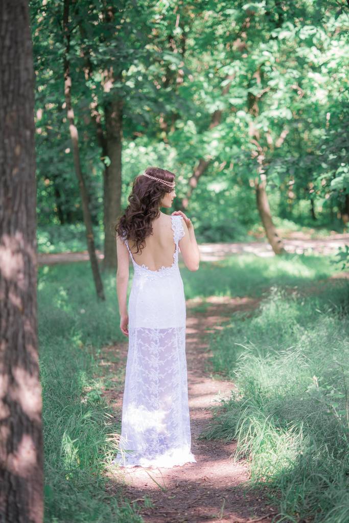 Houkutteleva nuori tyttö pitkä valkoinen mekko kaunis kampaus kesäpuistossa
 - Valokuva, kuva