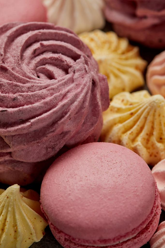 Pink zephyr with small yellow meringues and pink french macaroons - Photo, Image