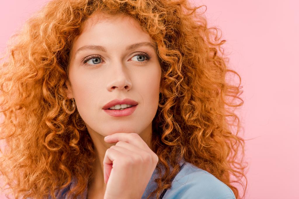attractive pensive redhead woman isolated on pink - Photo, Image