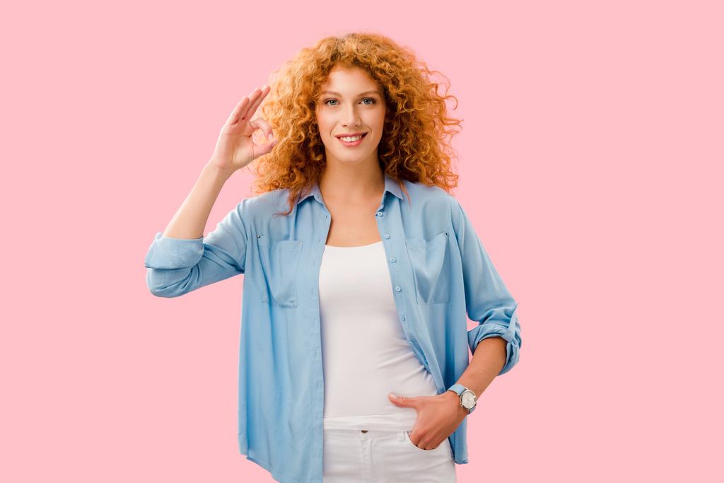 happy attractive redhead girl showing ok sign isolated on pink - Photo, Image