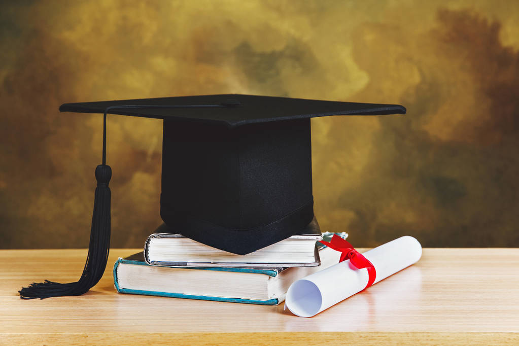 graduation concept.graduation cap,books with degree paper on woo - Photo, Image