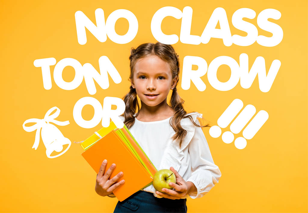 happy schoolchild holding tasty apple and books near no class tomorrow lettering on orange  - Photo, Image