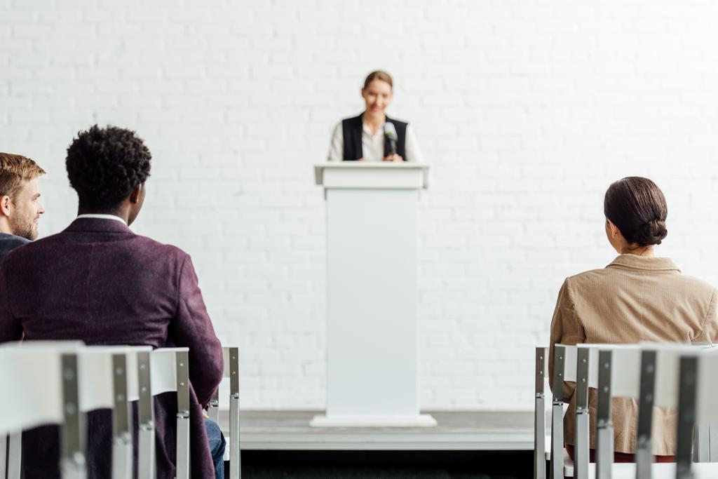 concentration sélective des gens d'affaires multiethniques assis pendant la conférence dans la salle de conférence
 - Photo, image