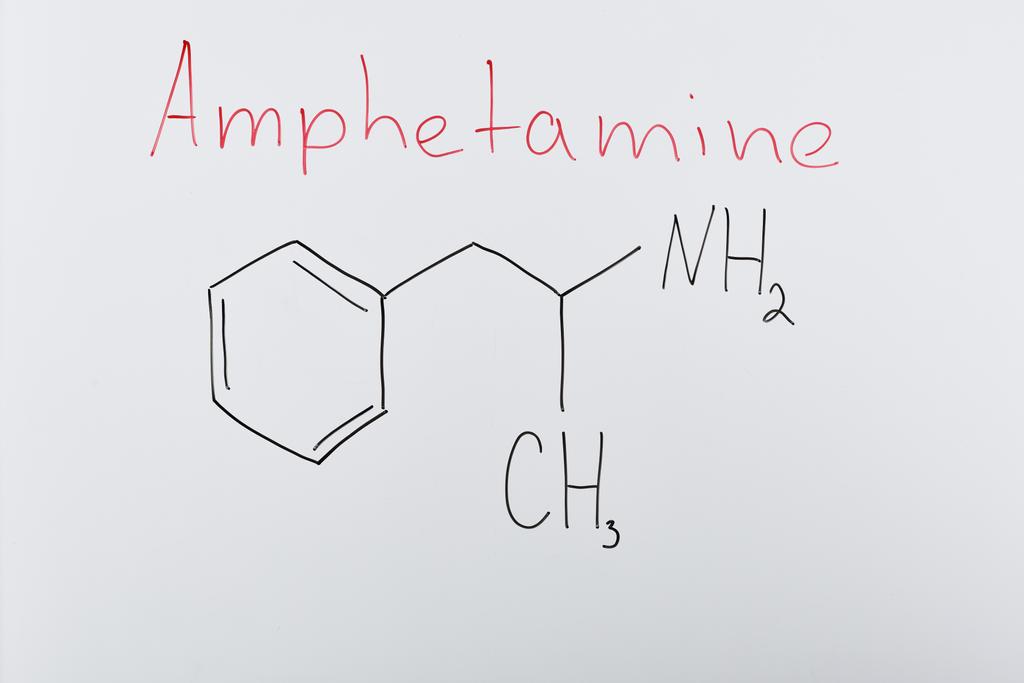 top view of white board with chemical formula and lettering amphetamine - Photo, Image