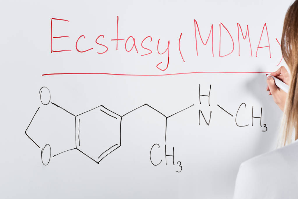 cropped view of woman writing ecstasy (mdma) on white board  - Photo, Image