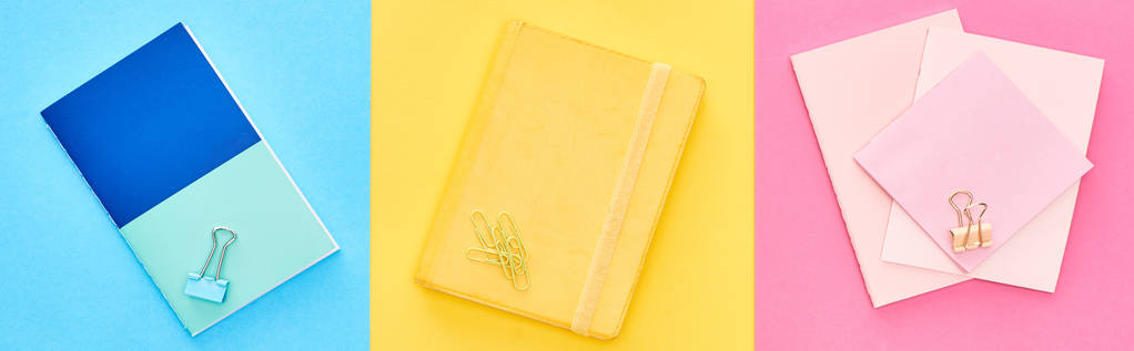 Panoramic shot of yellow and blue notepads near pink sheets of paper on tricolor background - Photo, Image