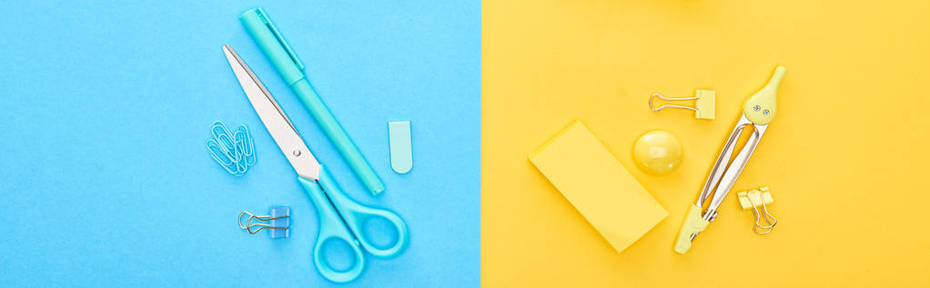 Foto panorámica de diferentes artículos de papelería azules y amarillos sobre fondo bicolor
 - Foto, Imagen
