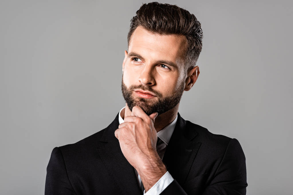pensive handsome businessman in black suit looking away isolated on grey - Photo, Image