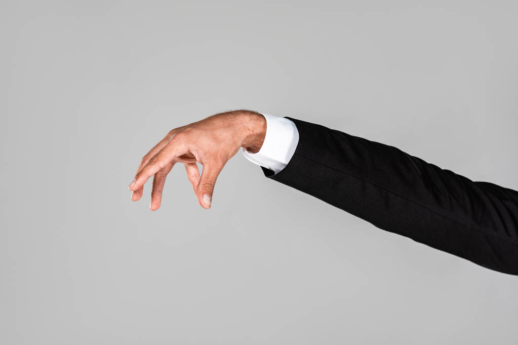 vista recortada de la mano del hombre de negocios gesto aislado en gris
 - Foto, Imagen