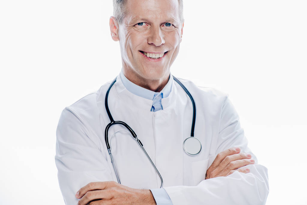 красивий лікар у білому пальто посміхається ізольовано на білому
 - Фото, зображення