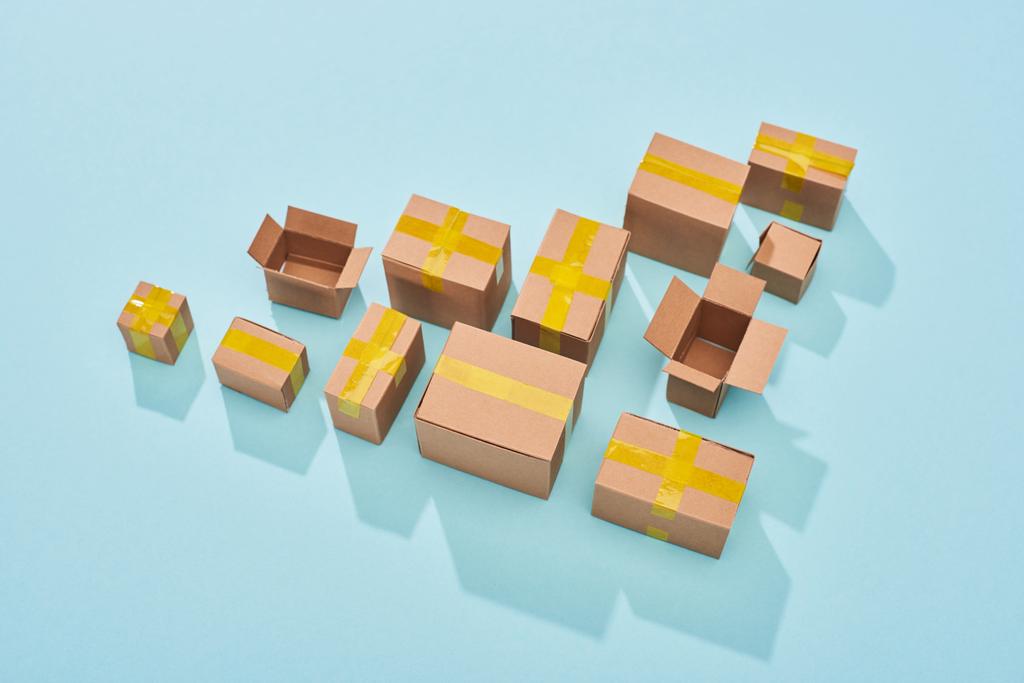top view of cardboard boxes on blue background with copy space - Photo, Image