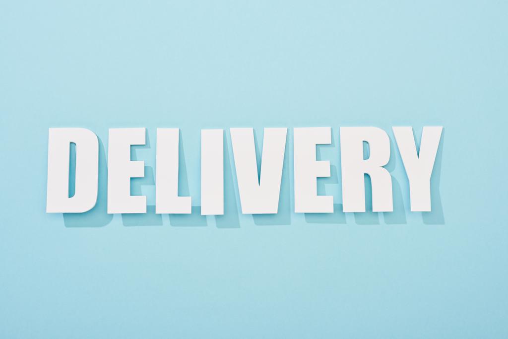 white delivery text with shadow on blue background with copy space - Photo, Image