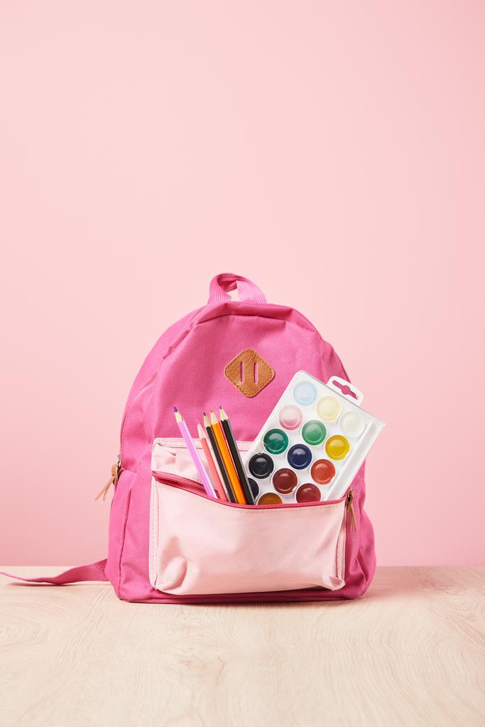 pink backpack with supplies in pocket isolated on pink - Photo, Image