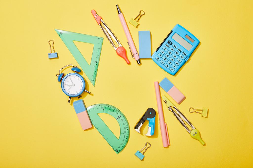 top view of school supplies scattered on yellow background - Photo, Image