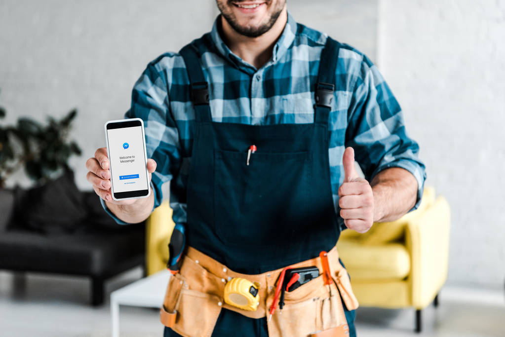 Kyjev, Ukrajina-31. července 2019: oříznutý pohled šťastného muže, který má telefon Smartphone s Kurýrní aplikací na obrazovce a ukazující palec nahoru  - Fotografie, Obrázek