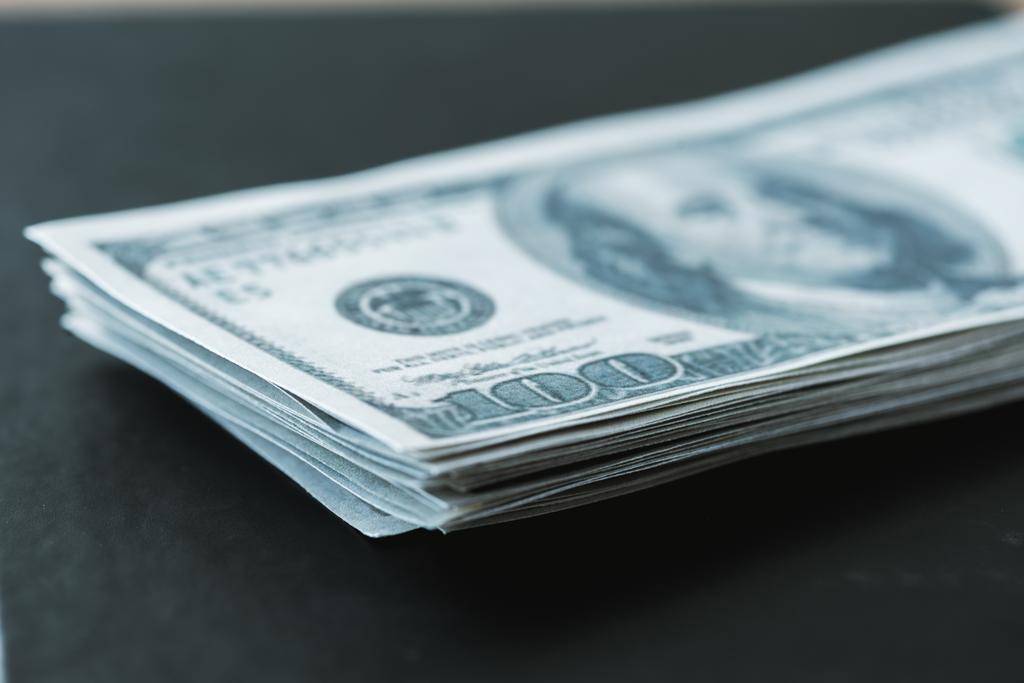 selective focus of stack with dollar banknotes on black  - Photo, Image