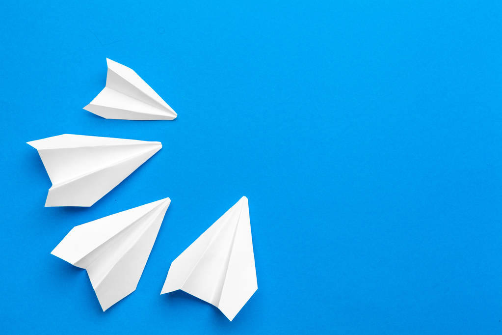 white paper airplane on a navy paper background - Photo, Image