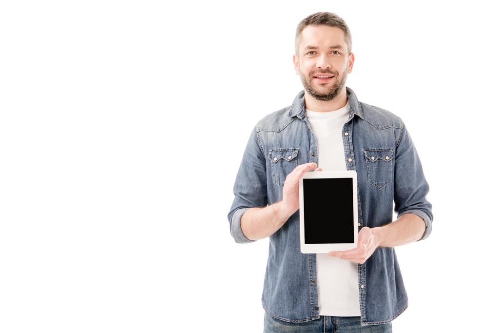 front view of smiling bearded man in denim shirt holding digital tablet with blank screen isolated on white - Photo, Image