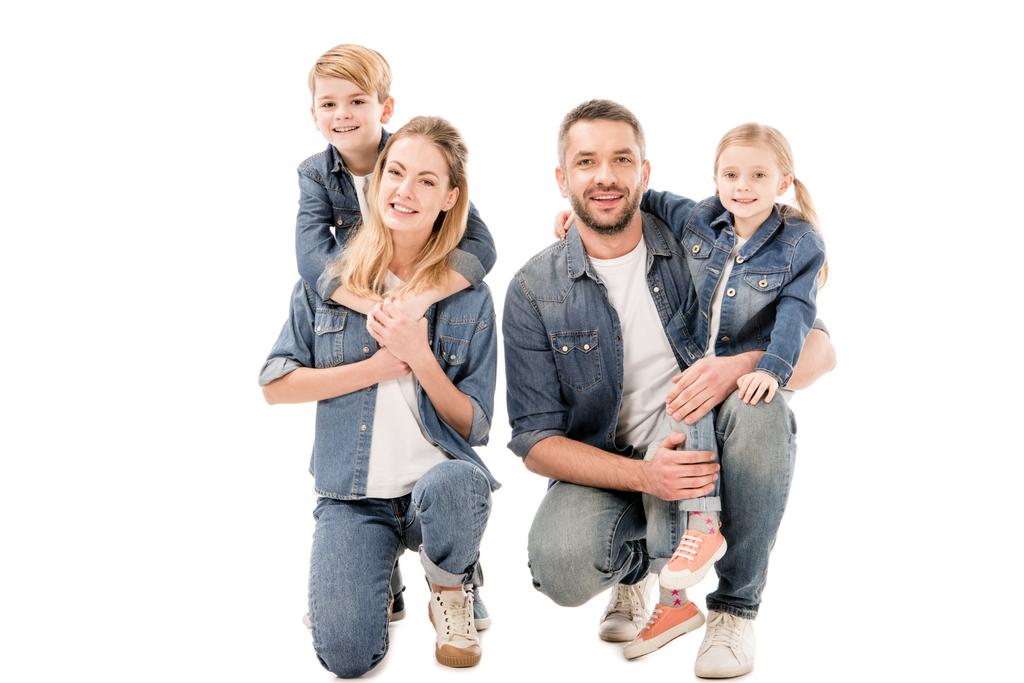 happy family in jeans embracing and smiling isolated on white - Photo, Image
