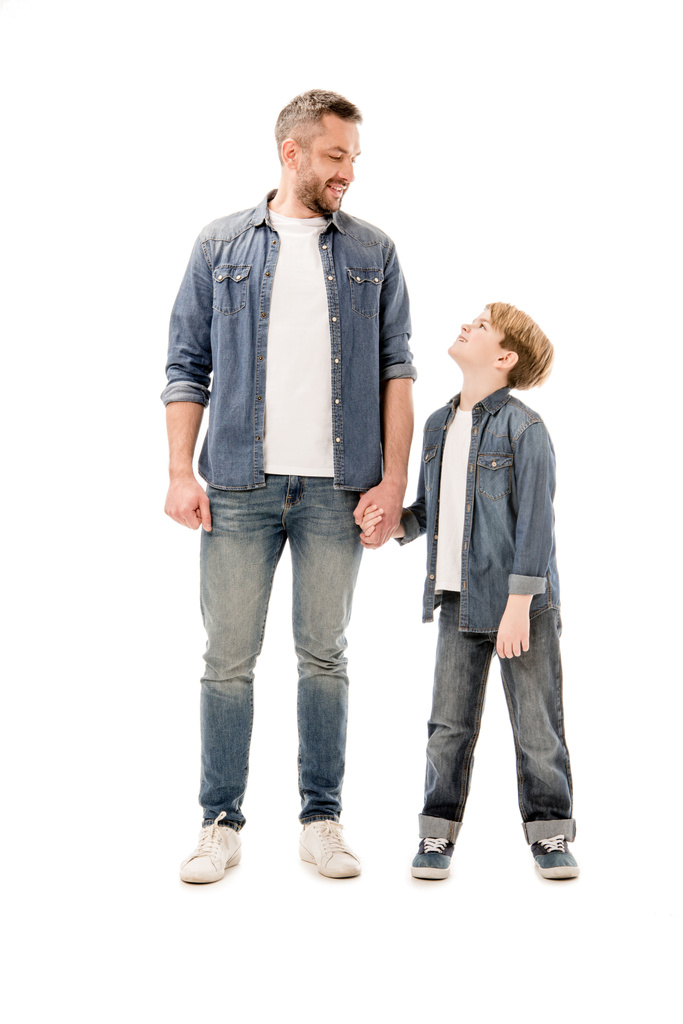 full length view of smiling son and father holding hands isolated on white - Photo, Image