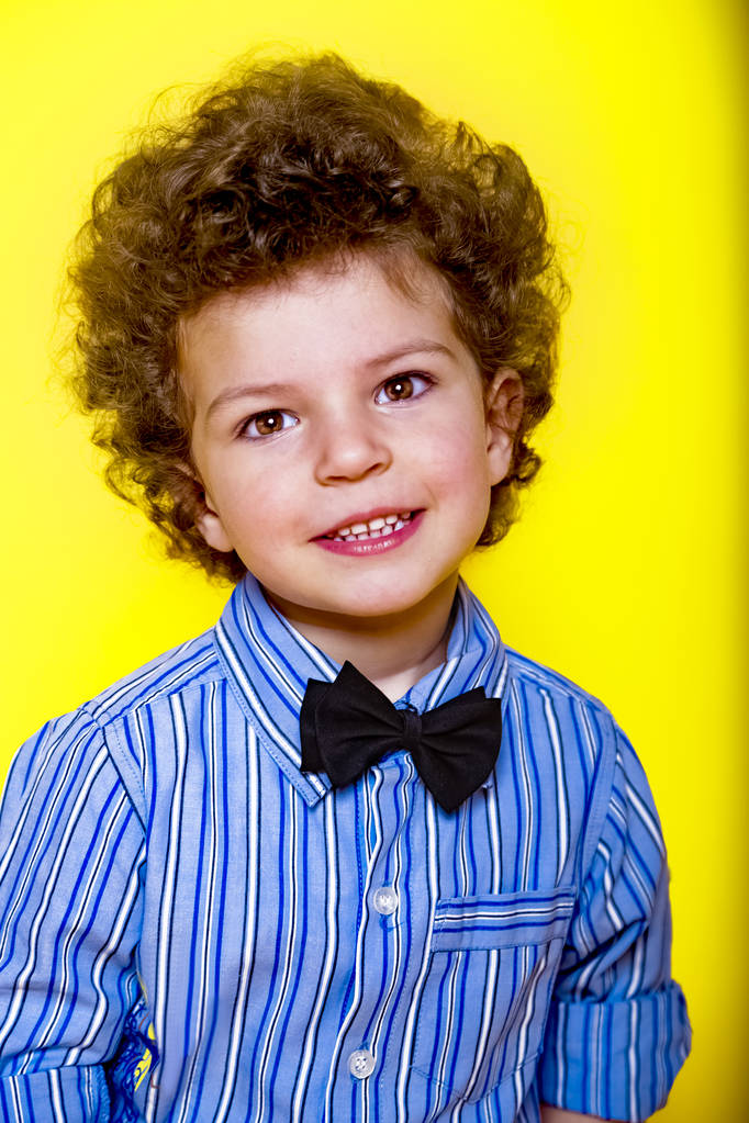 A kid portrait with curly hair on studio - Photo, Image