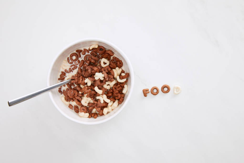 top view of cereal food inscription near bowl on marble surface - Photo, Image